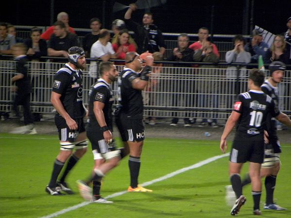 Johan Snyman et Saïd Hirèche félicitent leur coéquipier Sisa Koyamaibole pour son essai dans la rencontre entre le CA Brive et la Section Paloise